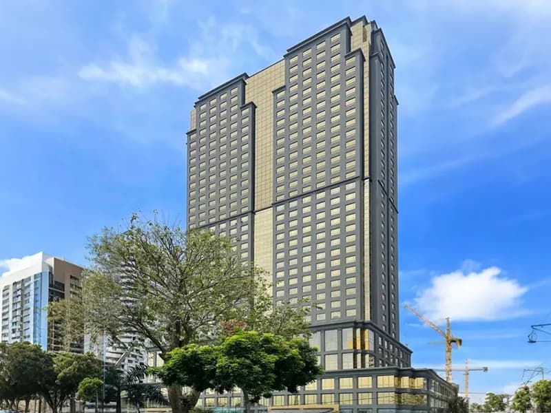 High-rise residential tower under construction, tropical cityscape
