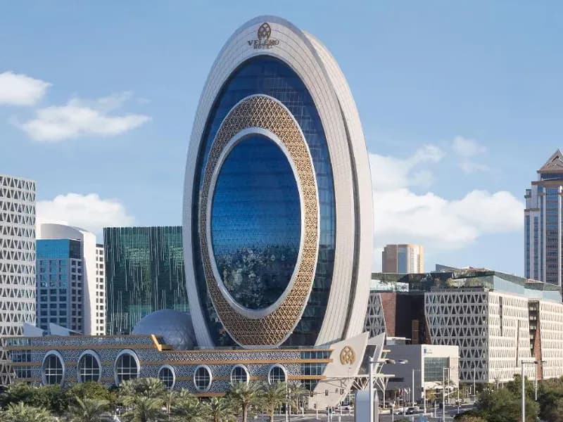 Velaro Hotel — oval glass-and-gold tower facade